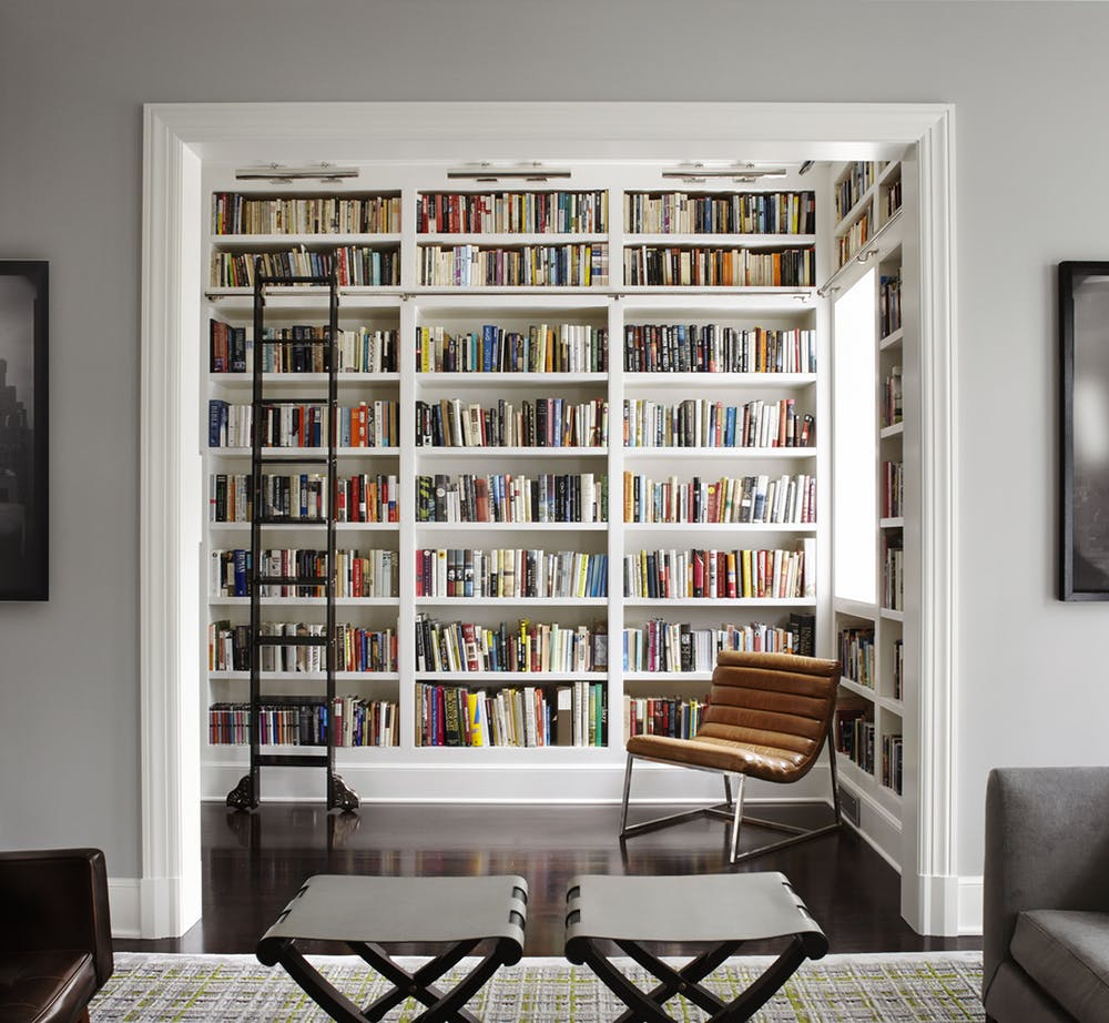 Antique ladder in modern home library from Dering Hall