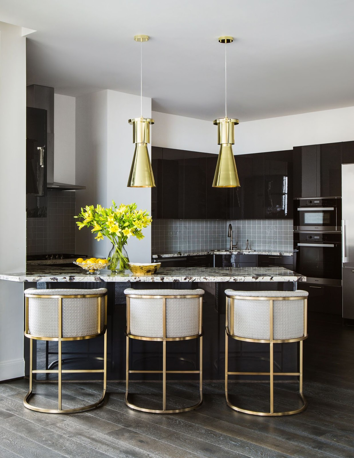 City Living - Dark kitchen cabinets with marble countertops and metallic gold barstools - Laura U Interior Design